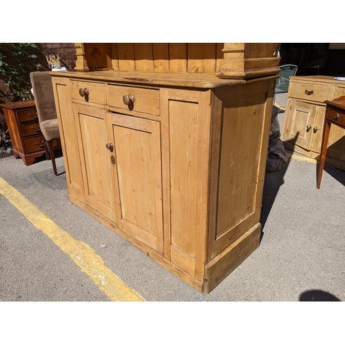 226 - A large Victorian pine dresser having a plate rack above two drawers and cupboards below, 218.5cm h ... 