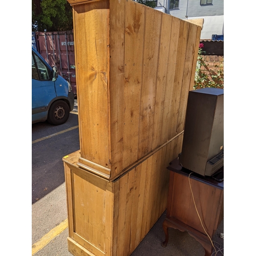 226 - A large Victorian pine dresser having a plate rack above two drawers and cupboards below, 218.5cm h ... 