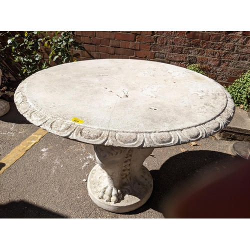 229 - A composition circular topped garden table, the column in the form of seated lions, 76cm h x 98cm w
... 