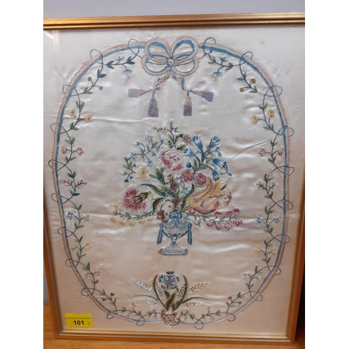 101 - Two late 19th/early 20th century silks, framed, comprising an embroidered urn of flowers surrounded ... 