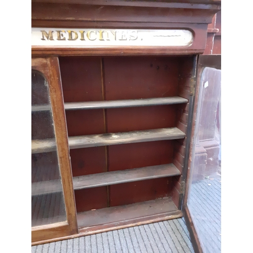 102 - A late 19th/early 20th century Patent Medicines Chemist display cabinet in mahogany with painted gla... 