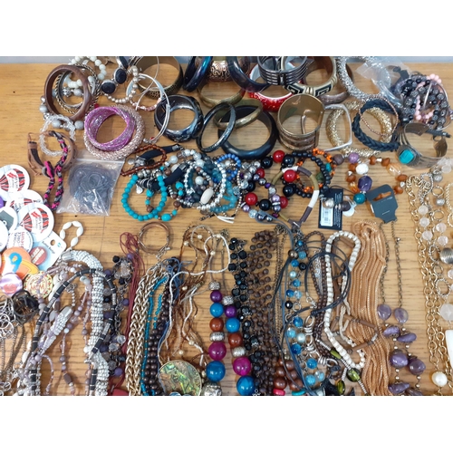 106 - A quantity of modern costume jewellery, mainly bangles and bead necklaces, together with four ladies... 