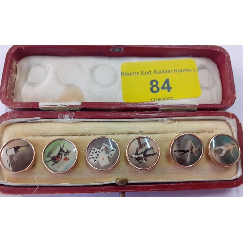 84 - A set of 6 early 20th Century gold plated and enamelled shirt studs with images of wine, horse ridin... 