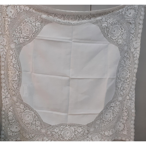 99 - A Mid 20th Century crotchet table cloth with embroidered circular white cotton insertions, 170cm x 1... 