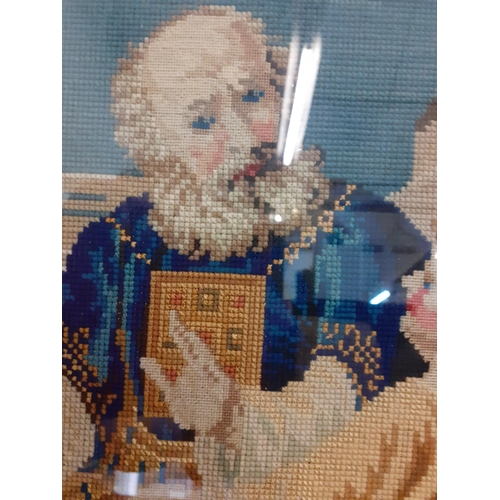 110 - A 20th century tapestry in woollen cross-stitch depicting a religious man teaching a child, framed i... 