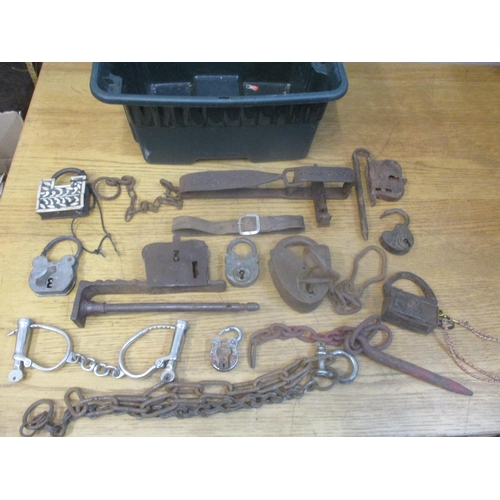 368 - A box of various Indian locks and other locks, a man trap, handcuffs and other items together with a... 