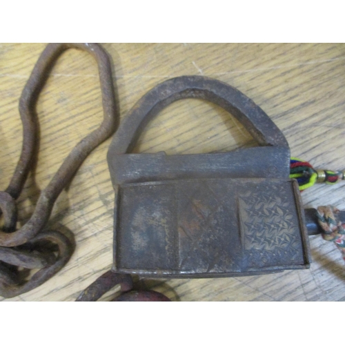 368 - A box of various Indian locks and other locks, a man trap, handcuffs and other items together with a... 