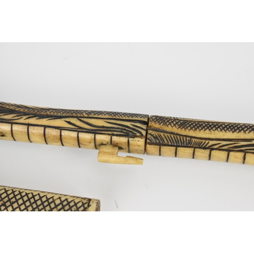 370 - A carved bone tribal blowpipe with dragon design, 125 cm long, together with a bamboo and wood blowp... 