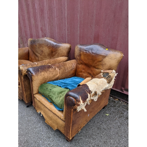 392 - A late 19th/early 20th century brown leather upholstered two seater sofa and matching armchair A/F
L... 