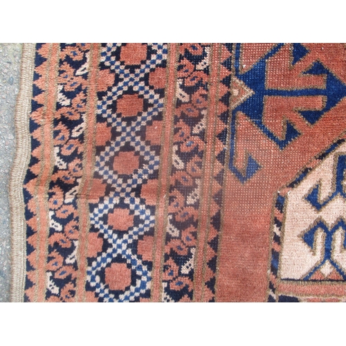 407 - An early 20th century hand woven small Middle Eastern rug, two central octagonal medallions with geo... 