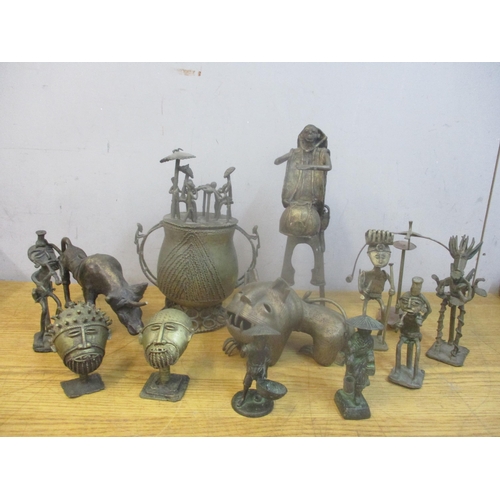 430 - A group of African Ashanti brass figures, mask busts, gold dust 'bronze' pot and cover, and animal m... 