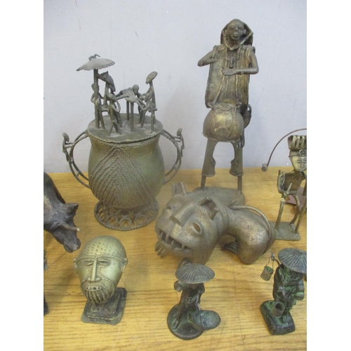 430 - A group of African Ashanti brass figures, mask busts, gold dust 'bronze' pot and cover, and animal m... 