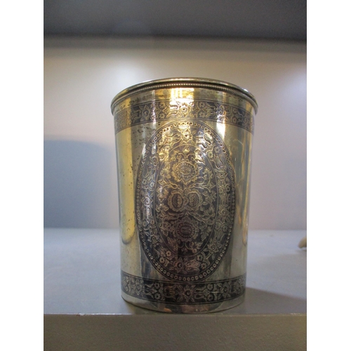 178 - An Indian niello white metal beaker having three oval floral medallions between two bands similarly ... 