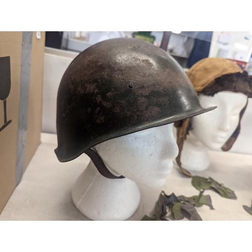 197 - A WWII era Russian steel infantry helmet with liner, a British 'Brodie' style steel helmet shell and... 