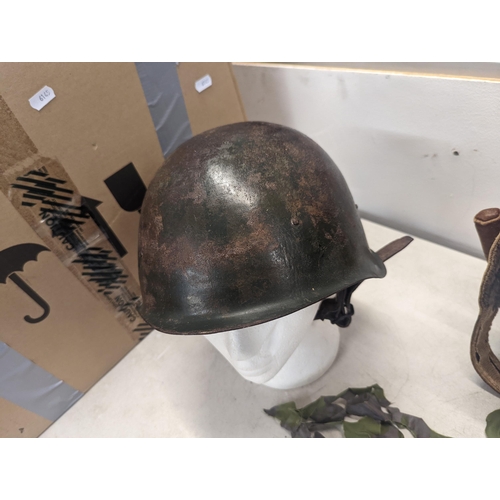 197 - A WWII era Russian steel infantry helmet with liner, a British 'Brodie' style steel helmet shell and... 