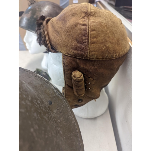 197 - A WWII era Russian steel infantry helmet with liner, a British 'Brodie' style steel helmet shell and... 