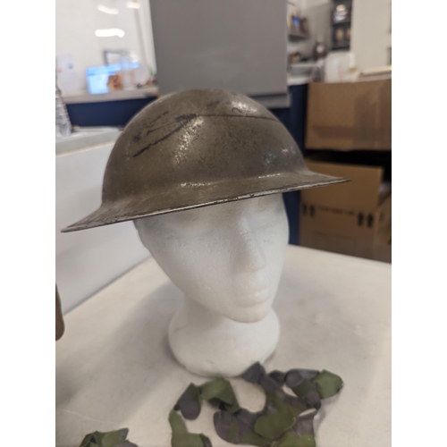 197 - A WWII era Russian steel infantry helmet with liner, a British 'Brodie' style steel helmet shell and... 