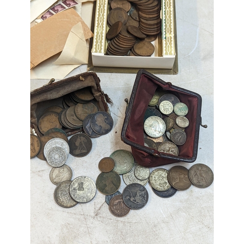 301 - A mixed lot of coins and stamps to include a quantity of Victorian and later pennies, George V and l... 