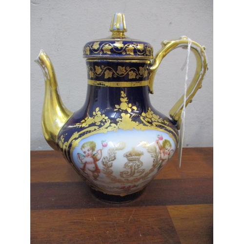 330 - A Sevres porcelain teapot and three coffee cans and saucers decorated with cherubs holding a flower ... 