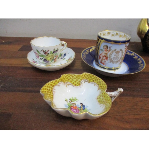 330 - A Sevres porcelain teapot and three coffee cans and saucers decorated with cherubs holding a flower ... 