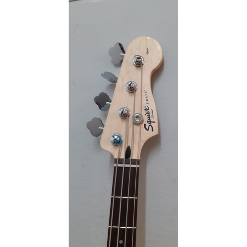 127 - A Fender Squier bass guitar made in Indonesia, serial number s/niCS13195747, a Fender guitar soft ca... 