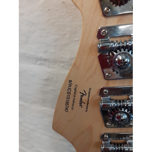 127 - A Fender Squier bass guitar made in Indonesia, serial number s/niCS13195747, a Fender guitar soft ca... 