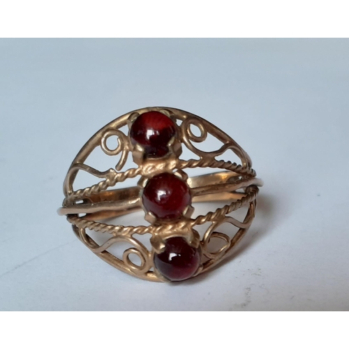 184 - A 9ct gold and 3 red stone cabochon ring in the Eastern style with filigree design, total weight 2.9... 