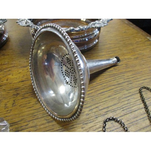 78 - A selection of silver plated items to include a pair of wine coasters, a meat skewer, various decant... 