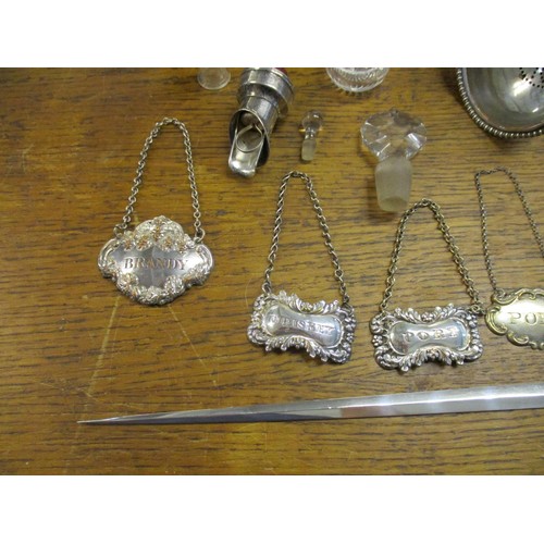 78 - A selection of silver plated items to include a pair of wine coasters, a meat skewer, various decant... 