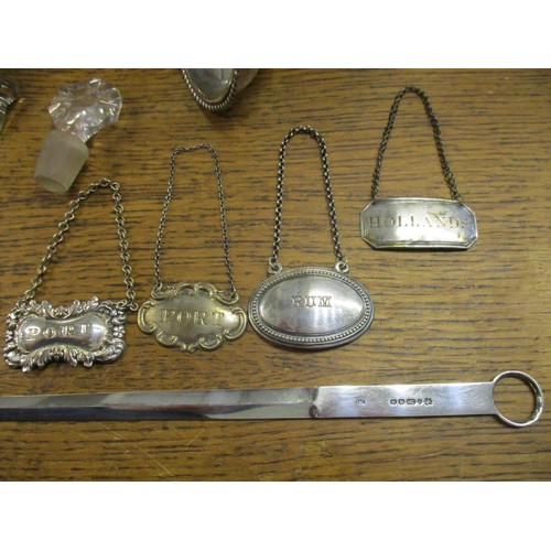 78 - A selection of silver plated items to include a pair of wine coasters, a meat skewer, various decant... 