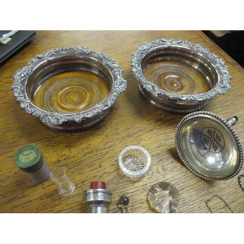 78 - A selection of silver plated items to include a pair of wine coasters, a meat skewer, various decant... 