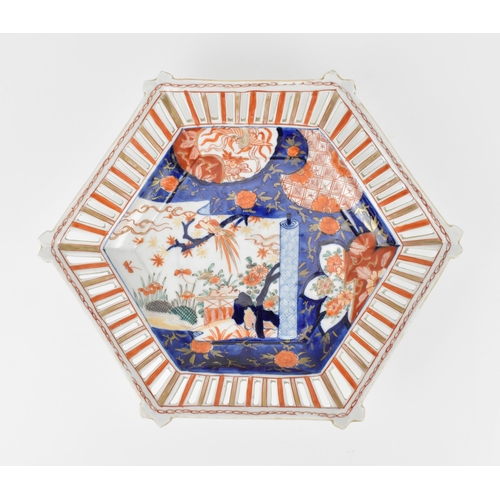 10 - A Japanese Edo period Imari porcelain octagonal dish, with a partly unrolled scroll depicting a natu... 