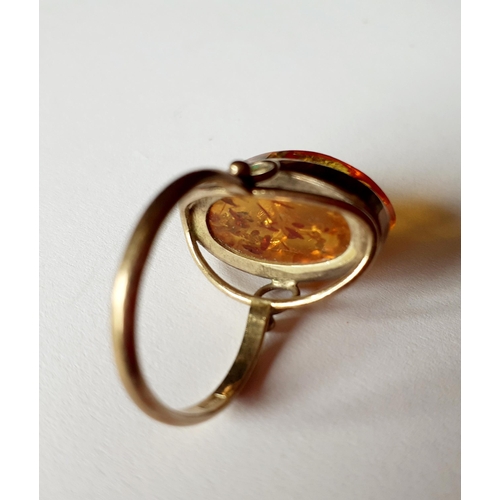 11 - A silver gilt and and amber dress ring having a raised mount, total weight 3.8g, UK ring size O. Loc... 