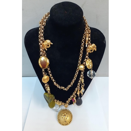 33 - A Martin James gold tone double chain necklace with multiple charm pendants in various forms togethe... 