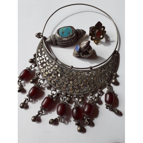 51 - A quantity of mainly Afghanistan and Turkmenistan jewellery to include white metal items inset with ... 