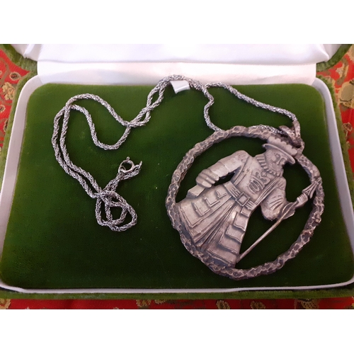 53 - A P.R.Mallory & Co oversized and silver tone pendant of a Beefeater on a silver tone rope chain toge... 