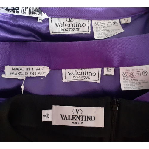 7 - Valentino Boutique- A purple silk 2 piece skirt suit having a vertical black ruffled trim to jacket ... 