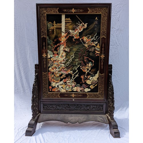 30 - A large Chinese hardstone, lacquer and hardwood screen, with central mythological battle scene, poss... 