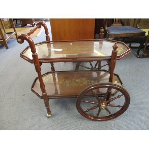 168 - A rosewood two tier trolley with large front wheels, inlaid floral brass decoration and glass tops
L... 