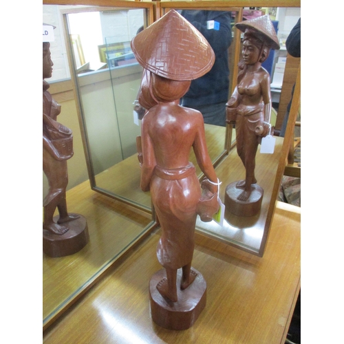 292 - A carved wooden Beli statuette of a woman in traditional dress, 56cm high Location: RAB