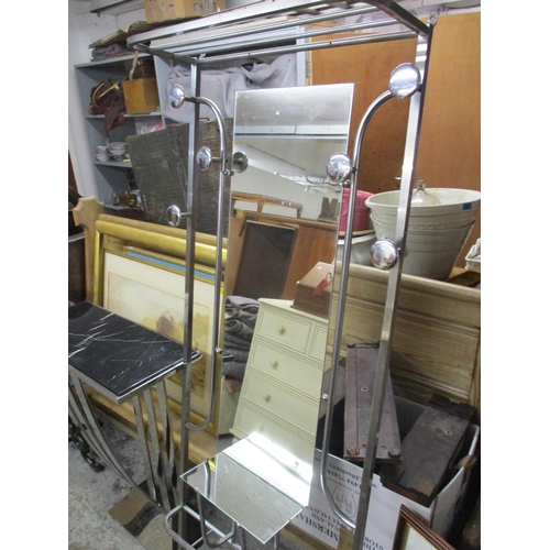 80 - A brushed silver finished hall stand in the modernist style with coat hooks and mirrored shelf and b... 