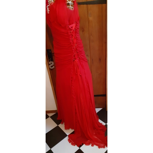 16 - A Bellville Sassoon Lorcan Mullany, red evening gown having a criss-cross ribbon design to the left ... 