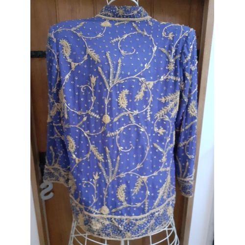 32 - An Indian blue ground cotton evening jacket by Burlington, Bombay, having gold metallic thread detai... 