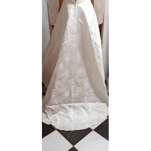 38 - A 1950's Emenson cream jacquard satin wedding dress with machine embroidered floral sprays throughou... 