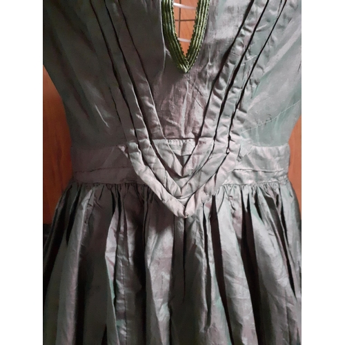 43 - A Victorian ladies hand-made silk dress in dark green having 3 horizontal black lace panels to the c... 