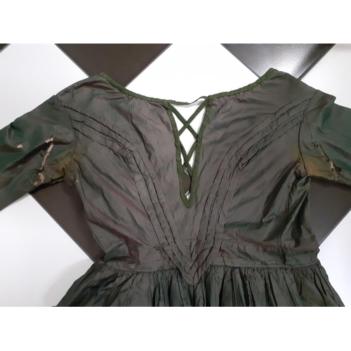 43 - A Victorian ladies hand-made silk dress in dark green having 3 horizontal black lace panels to the c... 