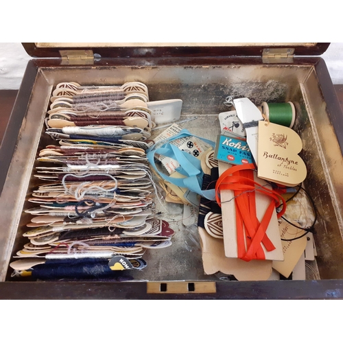 46 - A 19th Century rosewood and inlaid sewing box with fitted compartments, mother of pearl cotton reels... 