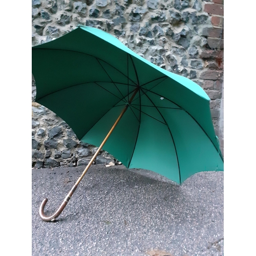 59 - An Edwardian Briggs green umbrella, Circa 1911 with incorporated racing pencil, refurbished by Brigg... 