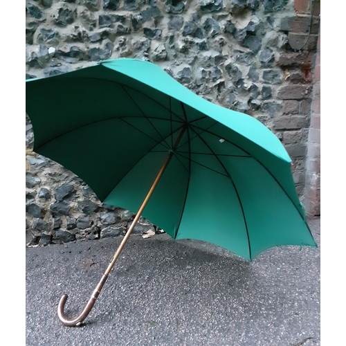 59 - An Edwardian Briggs green umbrella, Circa 1911 with incorporated racing pencil, refurbished by Brigg... 