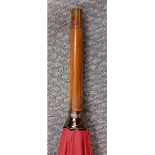 60 - An Edwardian Briggs burgundy umbrella, circa 1911, refurbished by Briggs in 2022, having a leather h... 